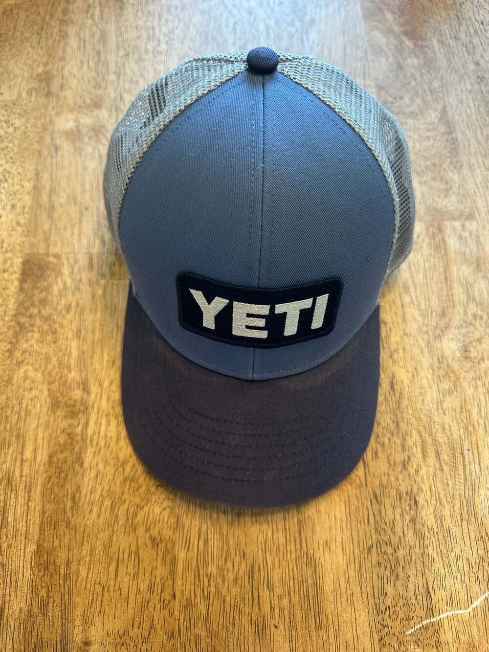 YETI Traditional Logo Badge Trucker Hat in Navy and Grey Mesh